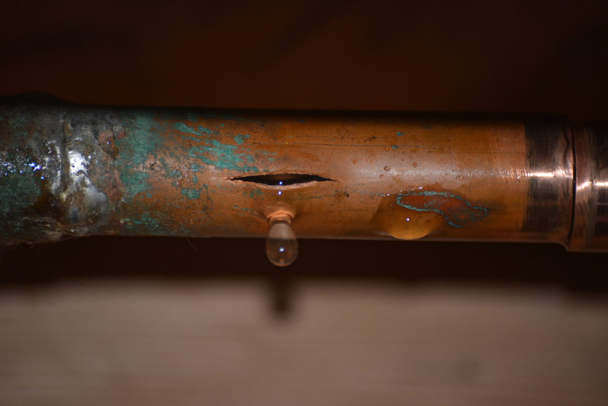 a corroded pipe with water leaking from it