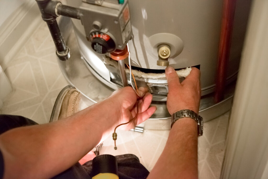 Plumber getting ready to flush a gas water heater